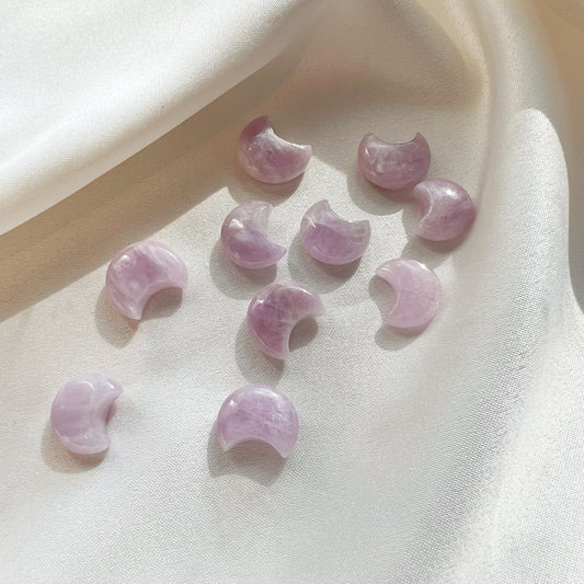 This listing is for one (1) Kunzite Moon.  Kunzite is drenched in sublime love and the divine light of being. While its gentle nature and feminine color scheme may seem whimsical, Kunzite is one of the strongest crystals in the pack for sweeping away any kind of dark feelings of doom and gloom.  Chakra: Heart  Element: Water  Zodiac: Taurus, Leo, Scorpio  Size: approximately .6in by .5 in