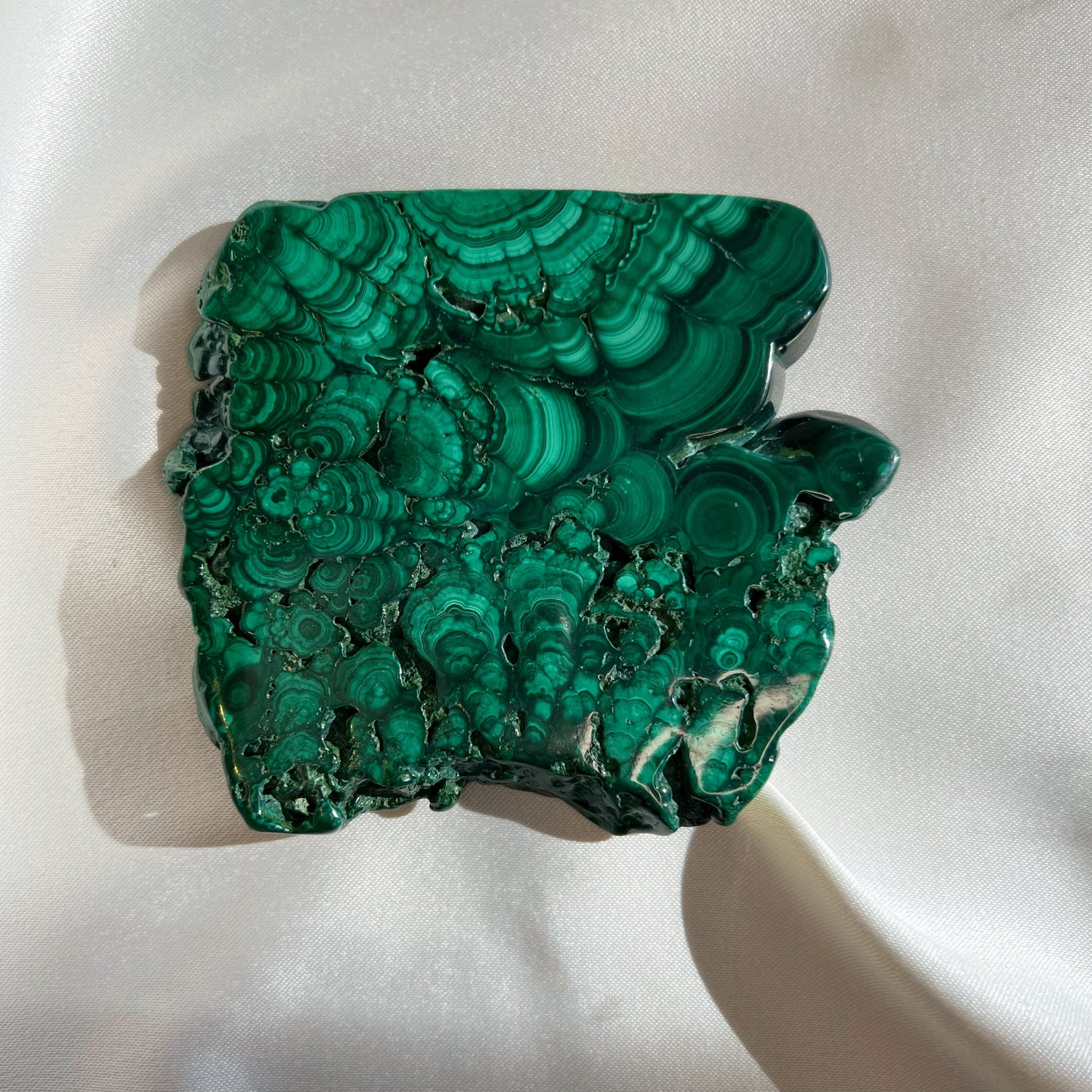 This listing is for one (1) Malachite Slab.  Known as the stone of transformation, Malachite helps bring energy and focus to new growth while pruning off the brambles holding you back. Malachite reminds us to turn over a new leaf. If you’re drawn to the vibrant Malachite crystal, it could mean that it’s time for a change.  Origin: Russia Slab 2:  3.5in by 3.15in, .185kg (shown in video)